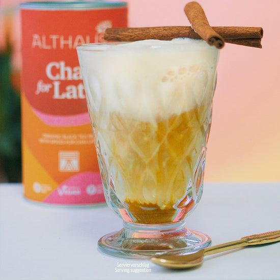 Glass of iced coffee with a cinnamon stick, Althaus can in the background