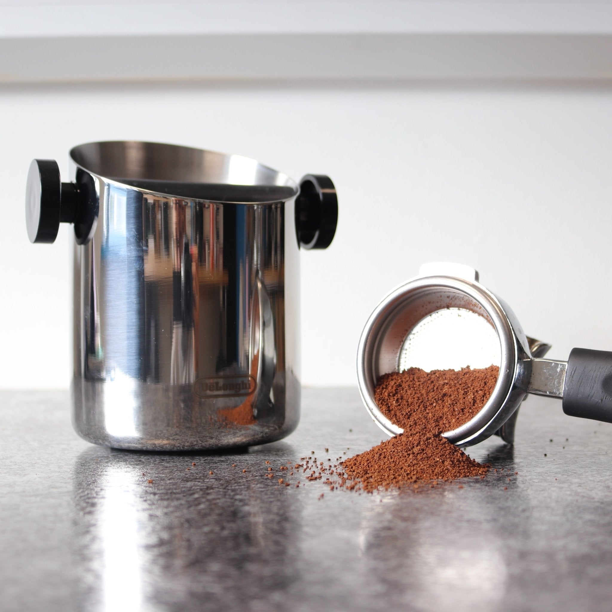De'Longhi Coffee Knock Box DLSC059 - Stainless Steel cyclinder Knock box with Black Rubber bar vertically across the top inside of the knockbox Coffee Roasters